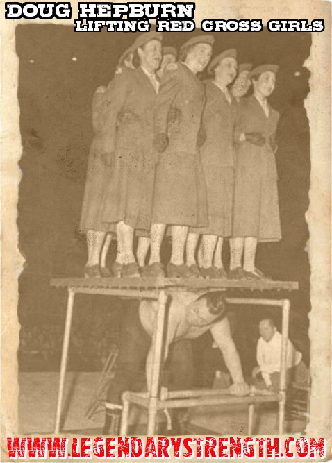 Doug Hepburn demonstates his strength by liting Red Cross Girls in 1955 in Toronto. 