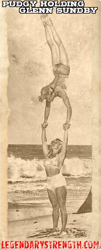 Strongwoman Abbye Pudgy Stockton holding 17 year old Glenn Sundby in a handstand. 