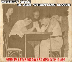 Mac Batchelor in arm wrestling match (right)